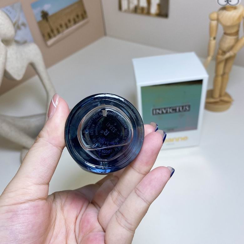 Rabanne Invictus Parfum gold cap top view with engraved R crest